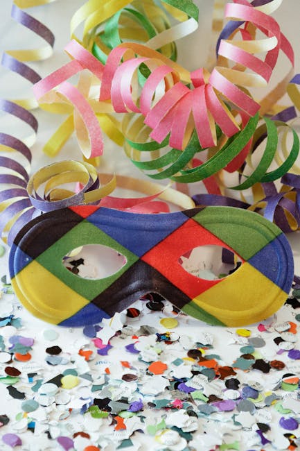 Colorful carnival mask with ribbons and confetti for festive celebration decor.